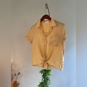 Light yellow button up tie shirt.